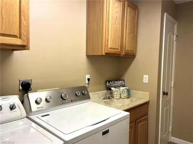 Laundry room with hookup for an electric dryer and cabinet space