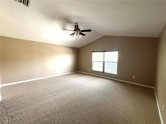 Empty room featuring carpet floors and ceiling fan