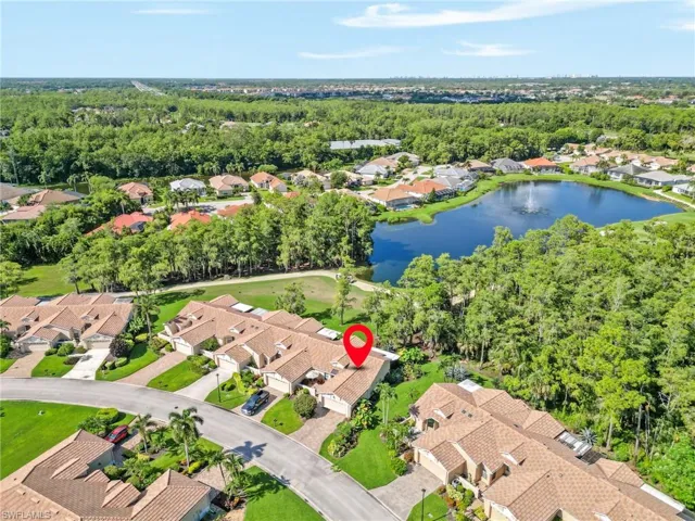 Birds eye view of property with a water view