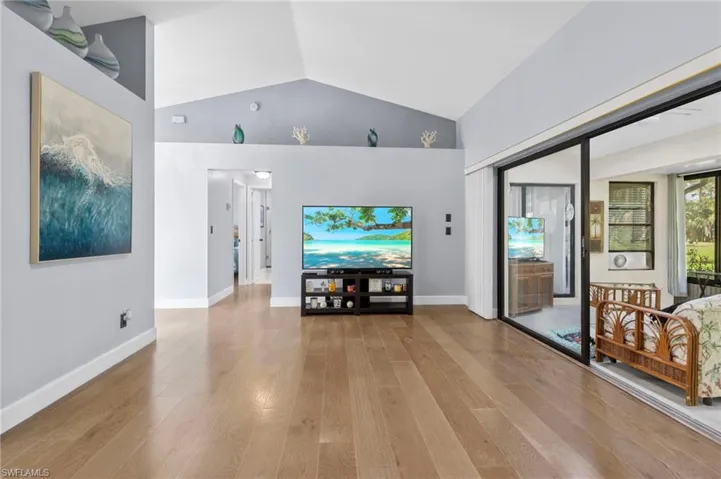 Living room featuring hardwood / wood-style floors and high vaulted ceiling