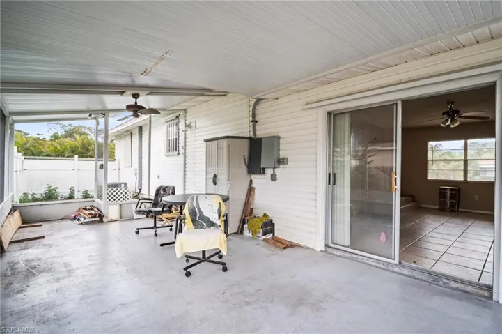 Unfurnished sunroom featuring ceiling fan