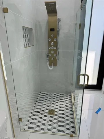 Bathroom with toilet and a shower with door