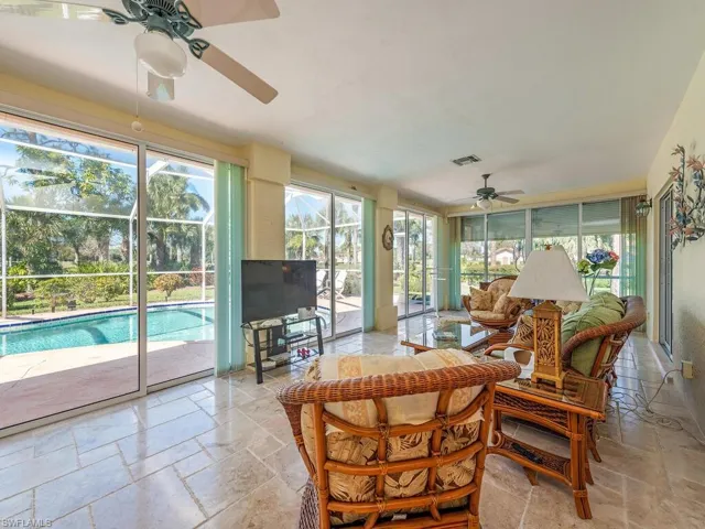 Sunroom with plenty of natural light and stone tile floors