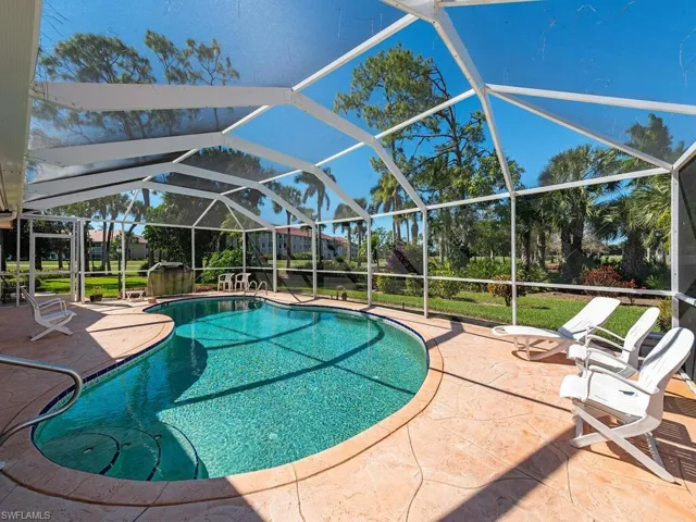 Swimming pool with glass enclosure, a patio area, and a sunroom