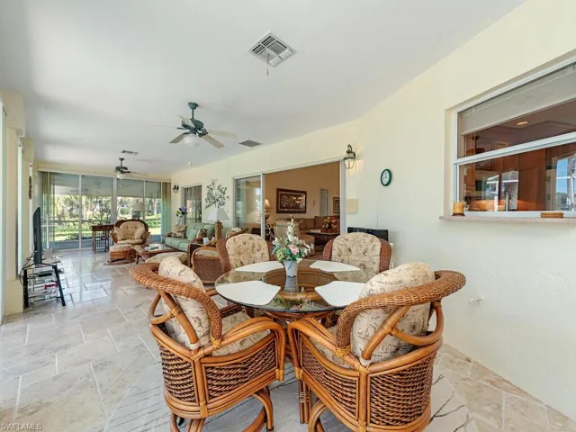Dining area with stone tile flooring and a ceiling fan
