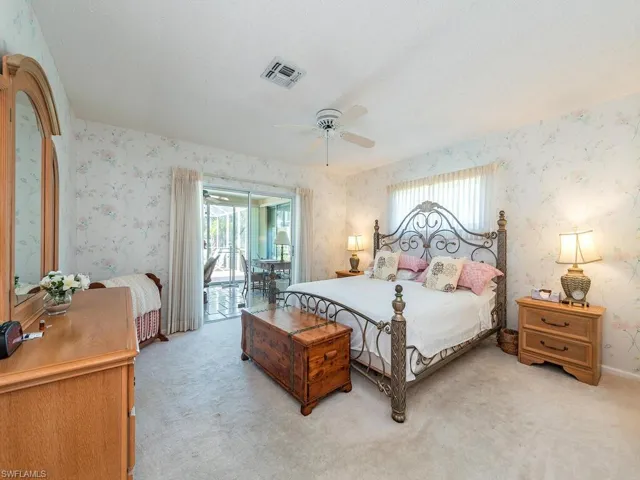 Bedroom featuring carpet flooring, a ceiling fan, access to outside, a textured ceiling, and wallpapered walls