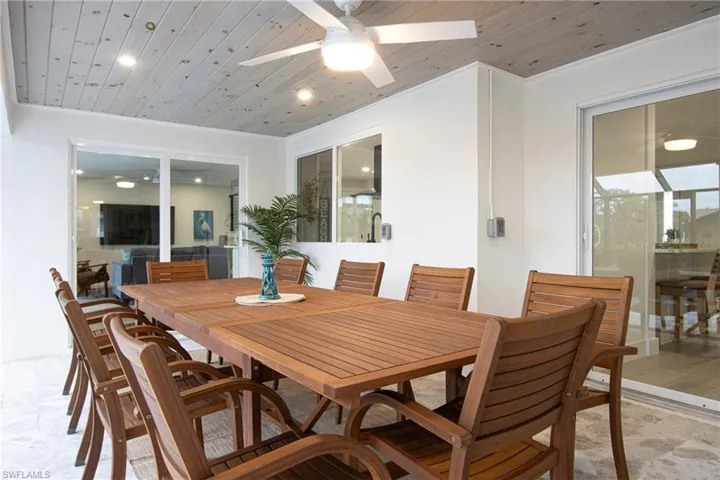 Dining space featuring wood ceiling and ceiling fan