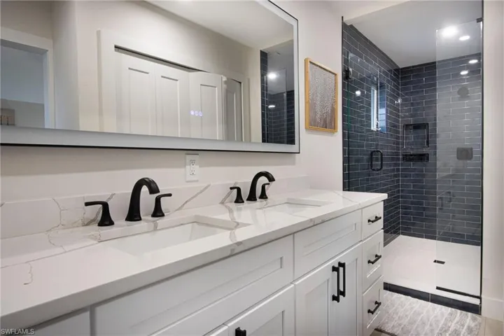 Bathroom with vanity and a shower with shower door