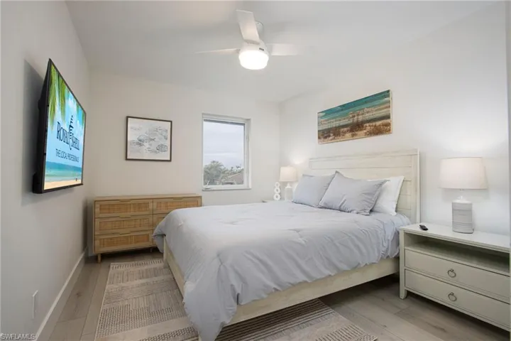 Bedroom with light hardwood / wood-style floors and ceiling fan