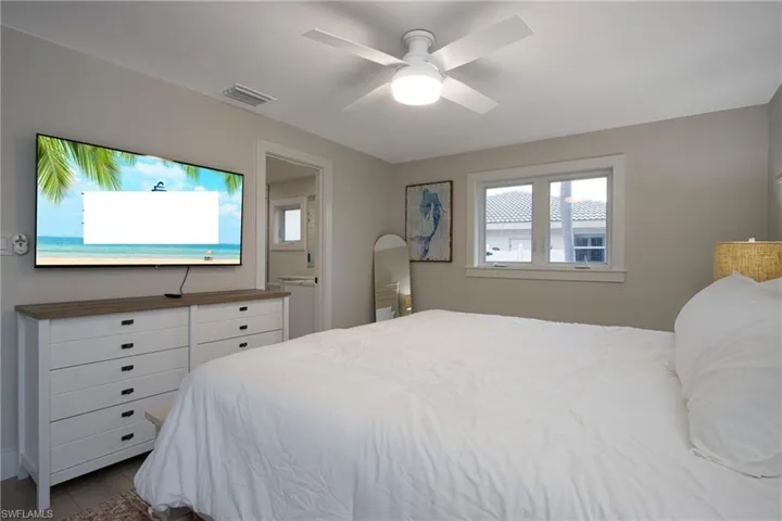 Tiled bedroom with ceiling fan