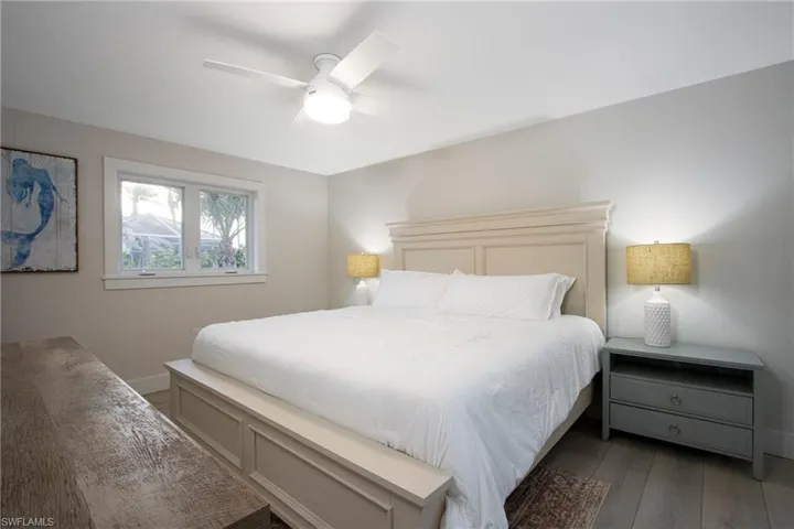Bedroom with dark wood-type flooring and ceiling fan