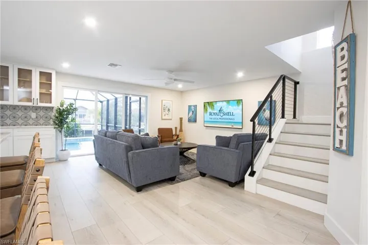 Living room featuring ceiling fan and light hardwood / wood-style flooring
