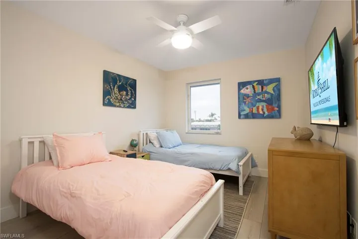 Bedroom featuring light hardwood / wood-style floors and ceiling fan