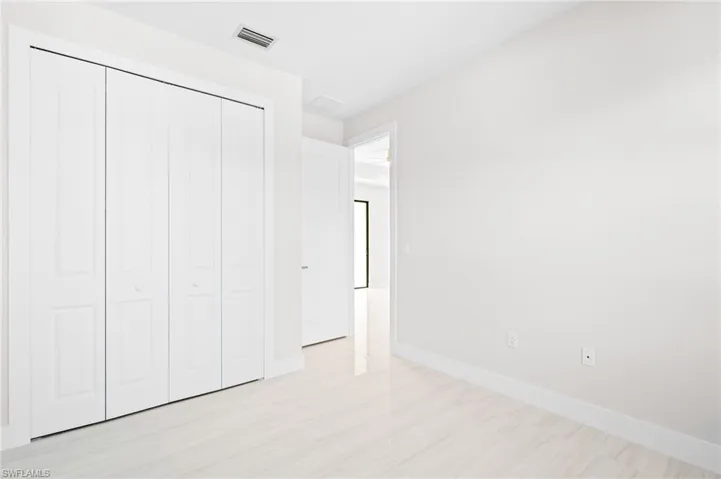 Unfurnished bedroom with a closet and light wood-type flooring