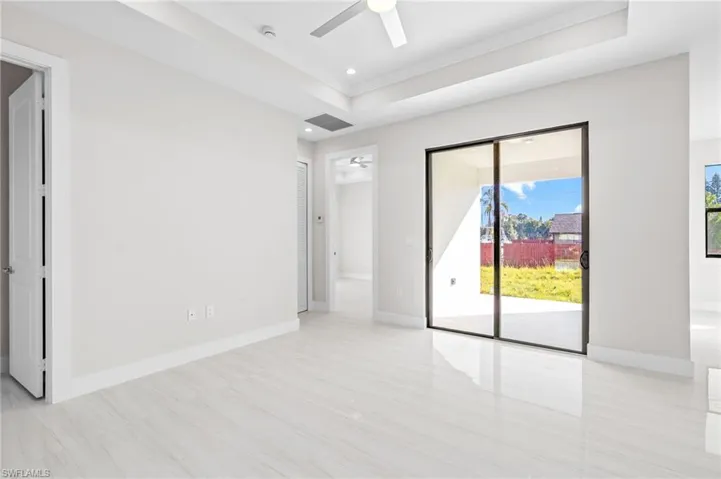 Spare room featuring ceiling fan, a tray ceiling, and recessed lighting