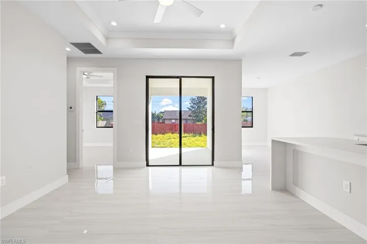 Spare room featuring ceiling fan, a raised ceiling, crown molding, and recessed lighting