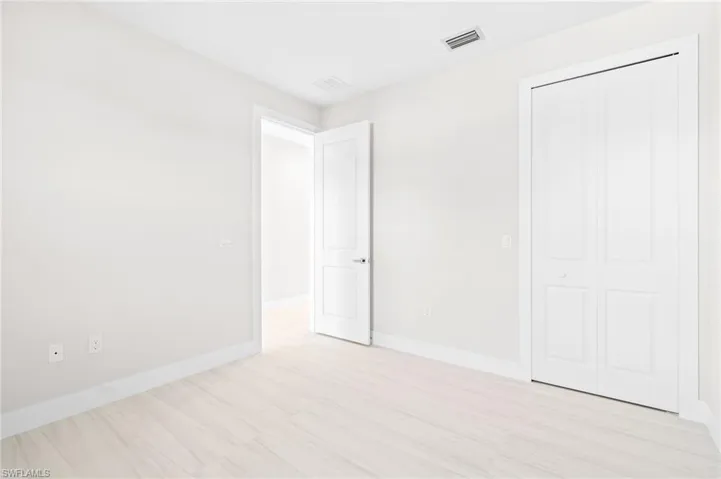 Unfurnished bedroom with a closet and light wood-type flooring