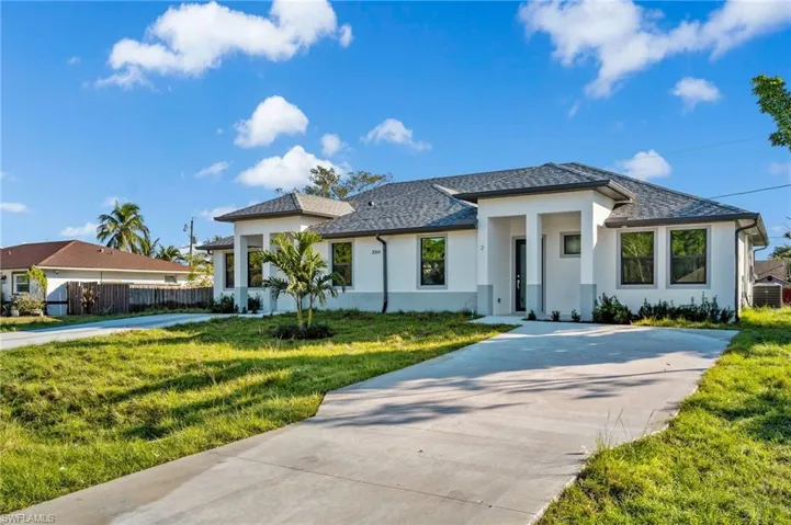 Prairie-style home with stucco siding and driveway
