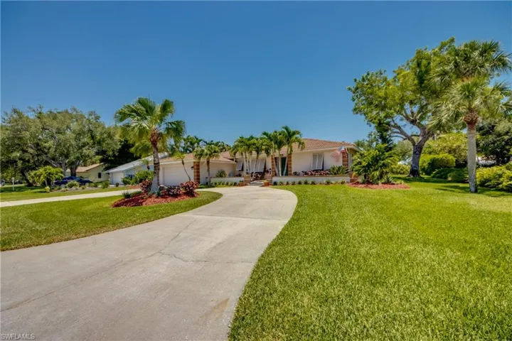 Single story home featuring a front lawn