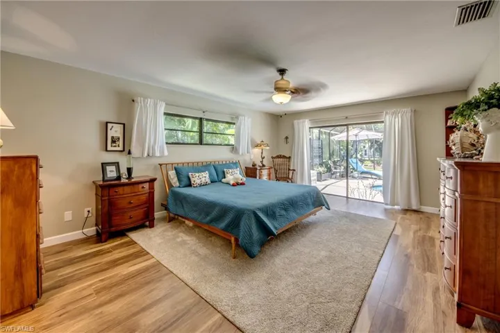 Bedroom with ceiling fan, light hardwood / wood-style flooring, and access to outside
