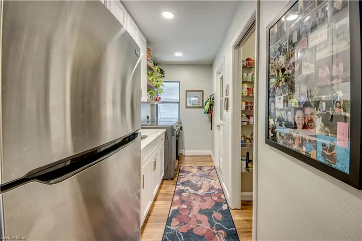 Laundry area with new refrigerator and pantry