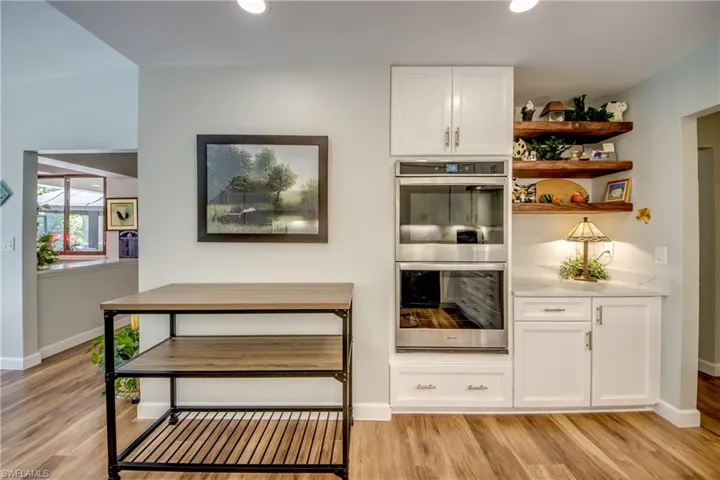 Double wall oven with a custom coffee bar with floating shelves