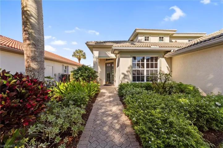 Property entrance featuring stucco siding and a tile roof