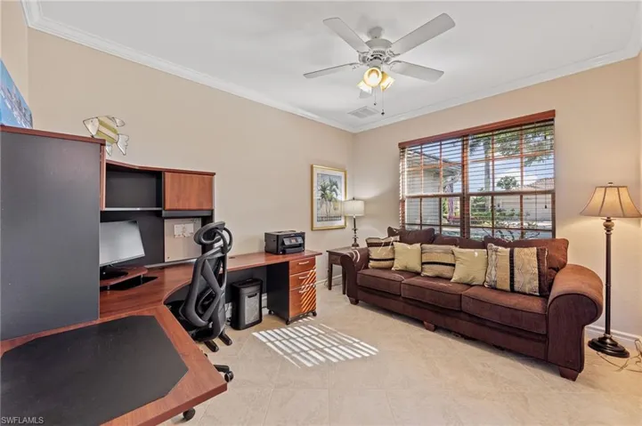 Office area featuring ornamental molding, a ceiling fan, and light tile patterned floors