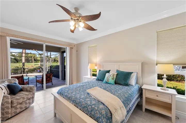 Bedroom with ornamental molding, access to exterior, multiple windows, a sunroom, and light tile patterned flooring