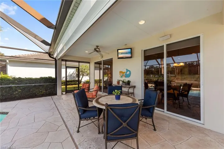 Sunroom / solarium featuring outdoor dining space, ceiling fan, and a patio area