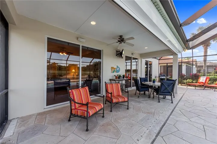 View of patio / terrace with outdoor dining space, a ceiling fan, glass enclosure, and a sunroom