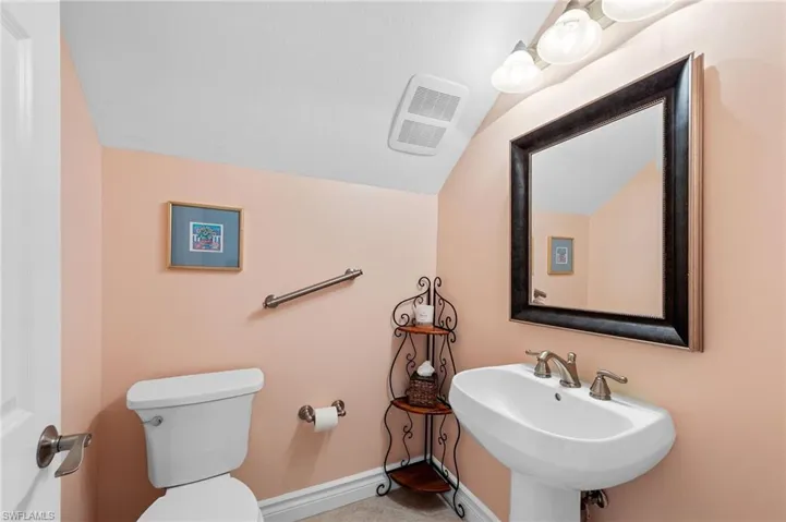 Bathroom featuring toilet and vaulted ceiling