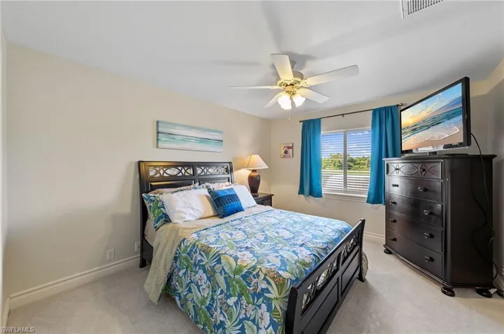 Bedroom featuring light carpet and ceiling fan