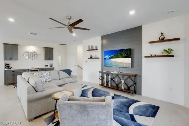 Living area featuring ceiling fan and recessed lighting