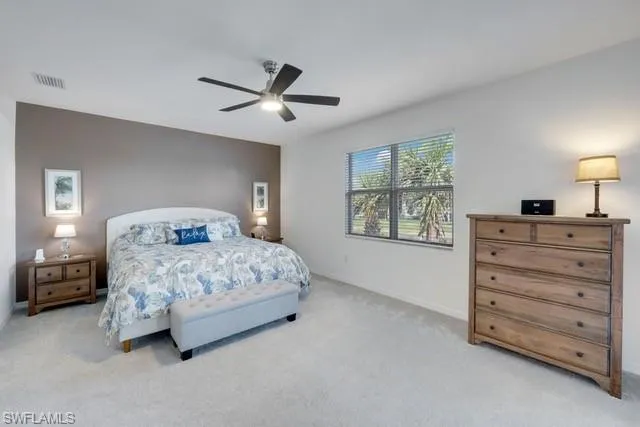 Carpeted bedroom with baseboards and ceiling fan