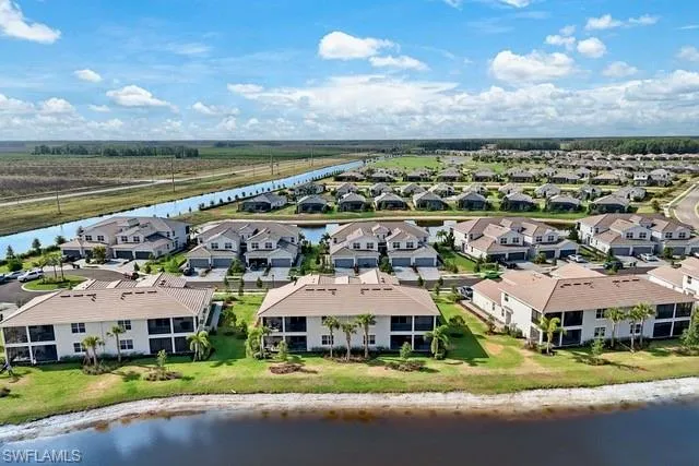 Aerial perspective of suburban area featuring a nearby body of water