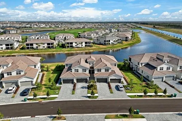 Aerial view of residential area featuring a nearby body of water