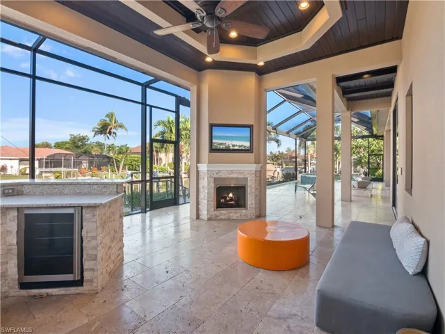 View of patio / terrace featuring ceiling fan and glass enclosure