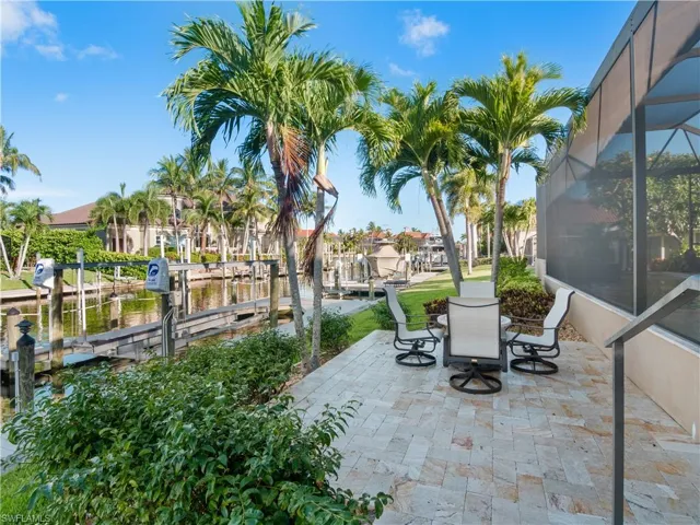 View of patio / terrace with a dock and a lanai
