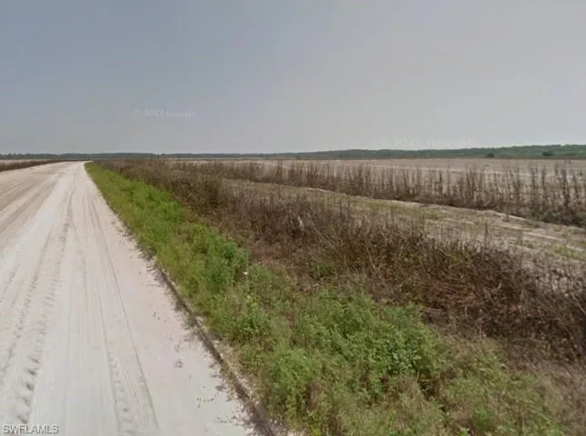 View of dirt / gravel road with a view of countryside