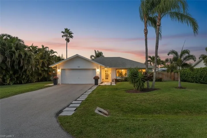 Single story home with asphalt driveway, a garage, and stucco siding