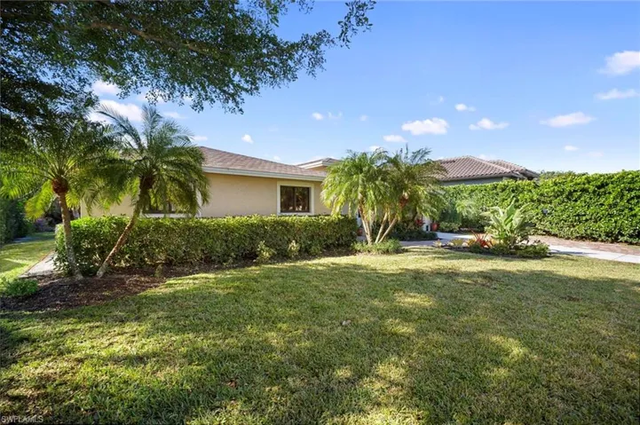 View of front of property with a front yard and stucco siding