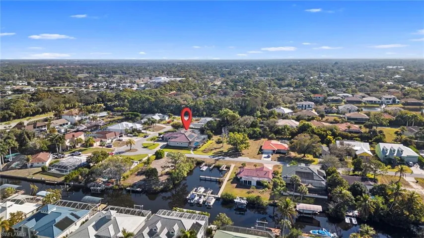 Aerial view of property's location with nearby suburban area and a large body of water