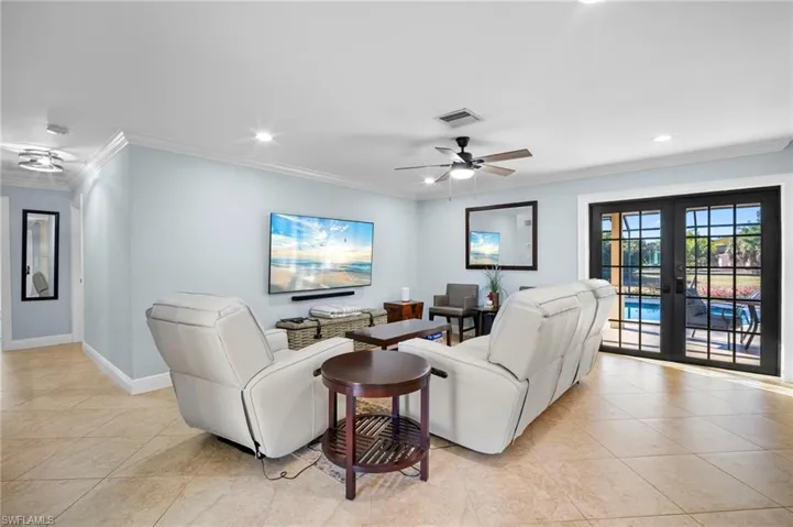 Living room with french doors, a ceiling fan, ornamental molding, recessed lighting, and light tile patterned floors