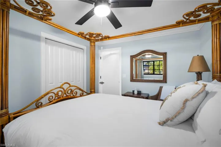Bedroom with ornamental molding, a closet, and a ceiling fan