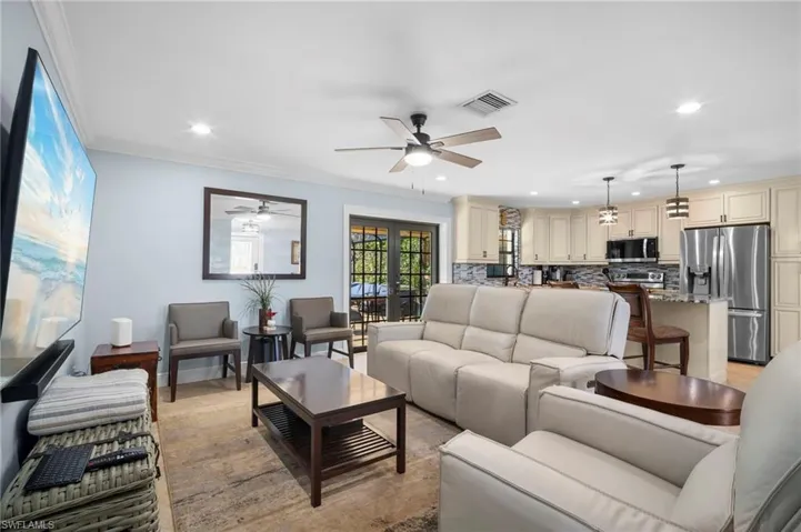Living room featuring french doors, recessed lighting, crown molding, and ceiling fan