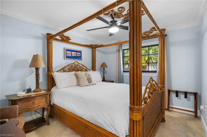 Bedroom with ornamental molding and a ceiling fan