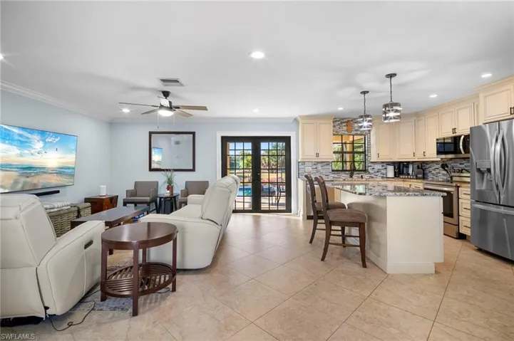 Living area featuring french doors, recessed lighting, and ceiling fan
