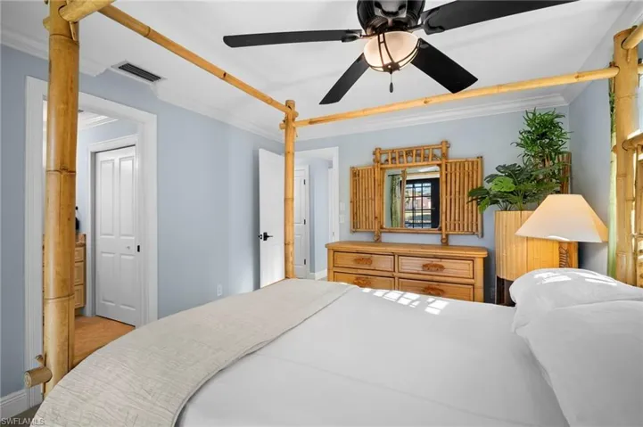 Bedroom with ornamental molding and ceiling fan