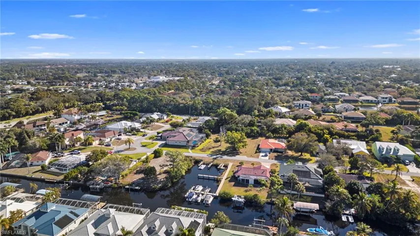 Aerial view of property's location with nearby suburban area and a large body of water